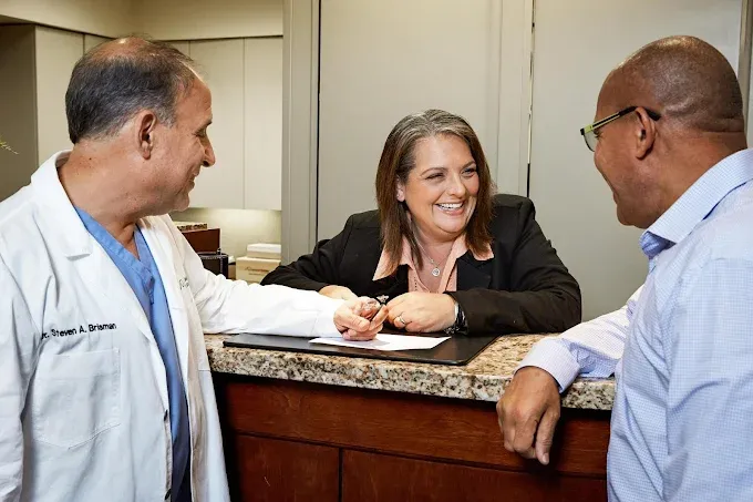 Dr. Brisman and staff at the front desk